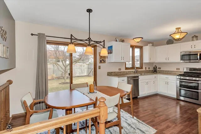 a kitchen with a table chairs stove and cabinets