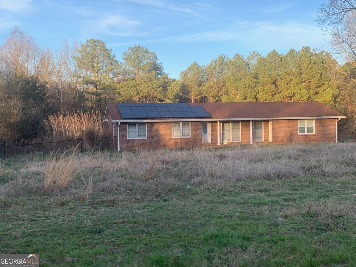 8750 Sandy Cross Road Carnesville, GA 30521 - Photo 2 of 6 a view of a house with a yard
