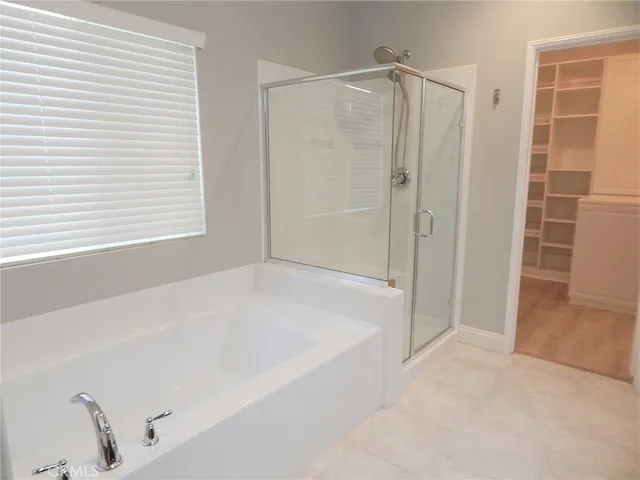 a bathroom with a bathtub and a shower