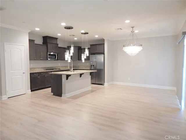 a kitchen with stainless steel appliances granite countertop a sink and cabinets
