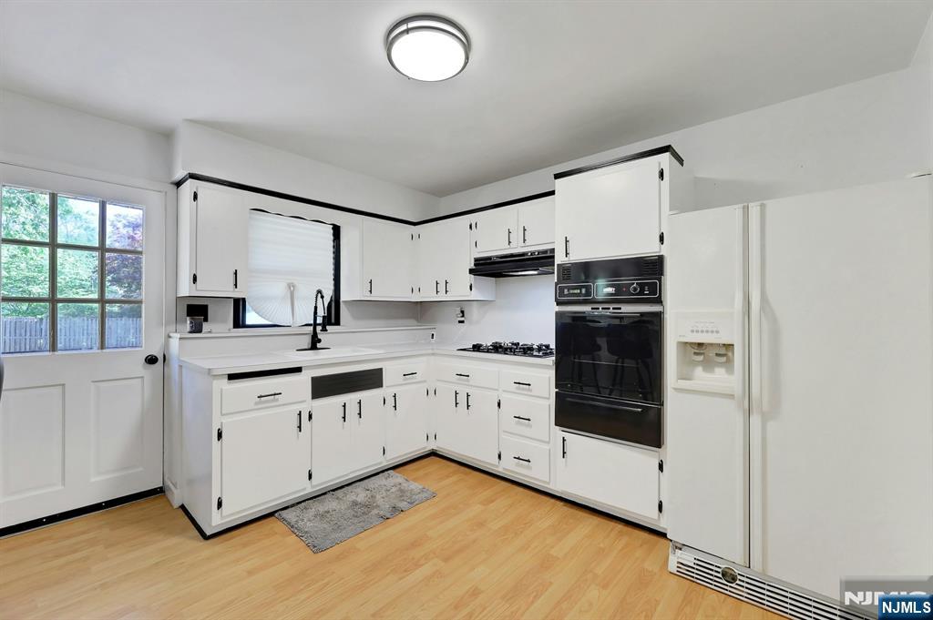 20 Blue Hill Road Norwood, NJ 07648 - Photo 35 of 49 a kitchen with white cabinets and white appliances