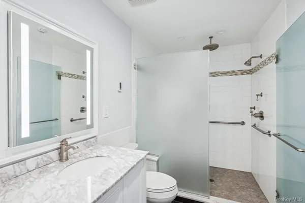 a bathroom with double vanity sinks and a mirror