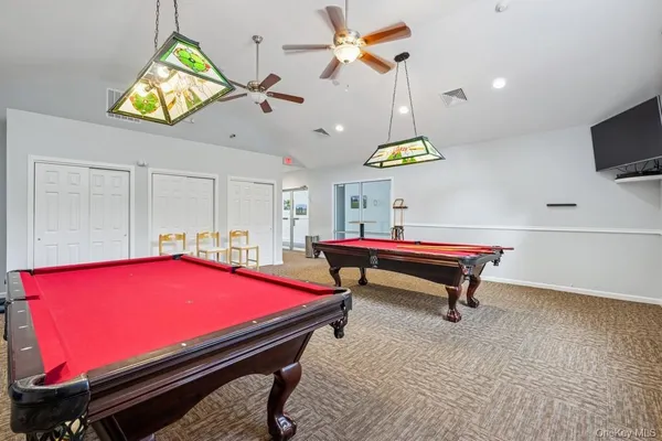 a living room with fireplace furniture and a large window