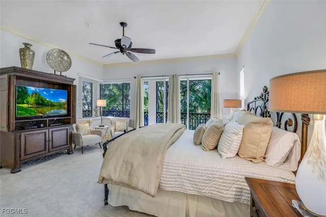 a bedroom with a large bed and a flat screen tv