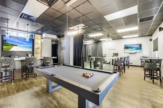 a outdoor space with lots of tables a large window and chairs