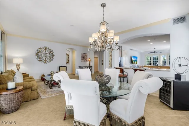 a dining room with furniture a chandelier and window