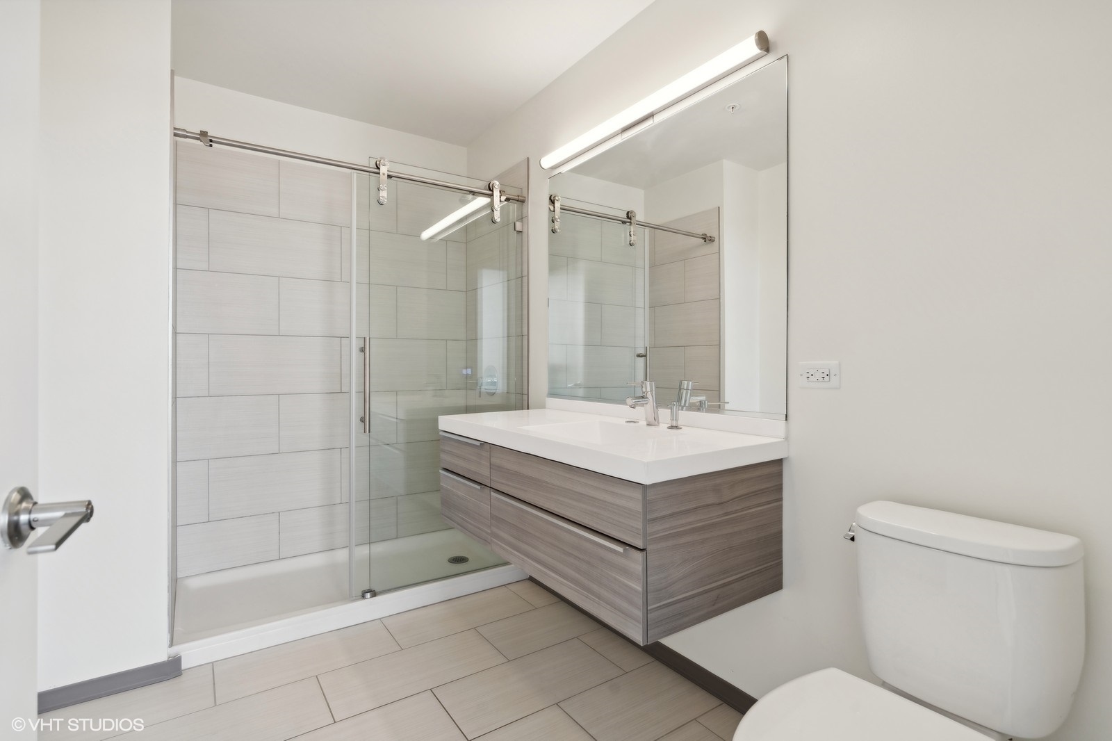 1920 North Milwaukee Avenue, Unit 407 Chicago, IL 60647 - Photo 12 of 19 a bathroom with a sink a toilet and shower