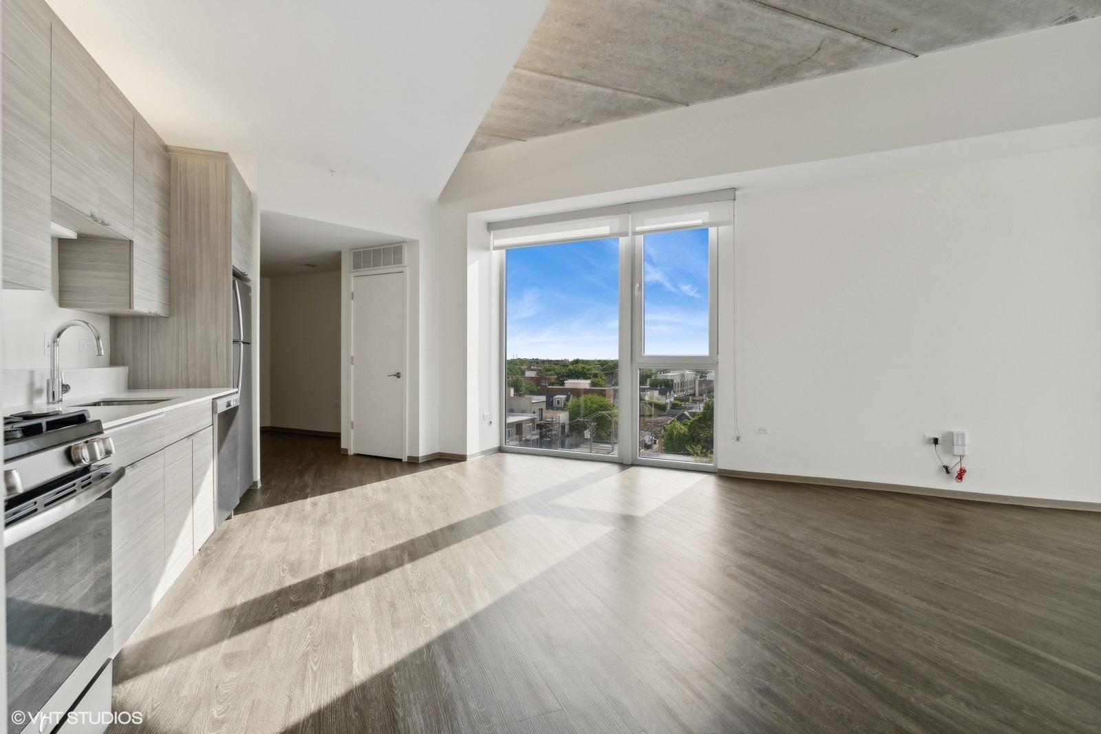 1920 North Milwaukee Avenue, Unit 407 Chicago, IL 60647 - Photo 6 of 19 a view of a kitchen with wooden floor and a sink