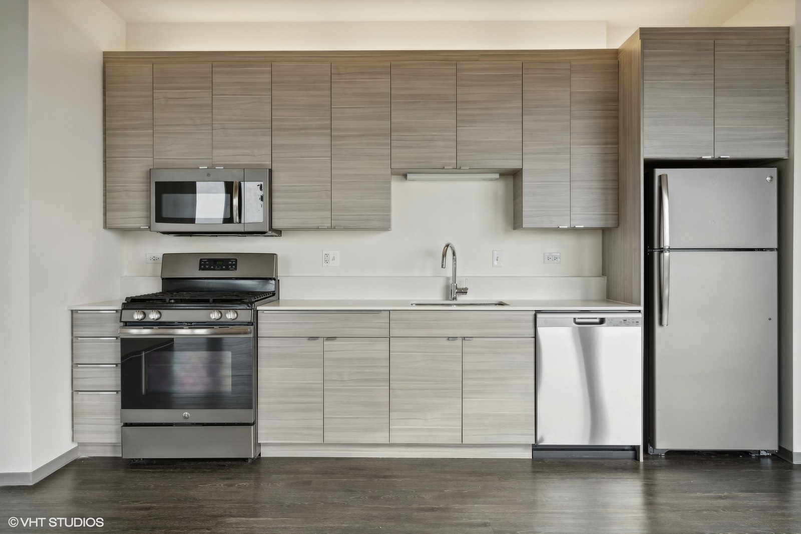 1920 North Milwaukee Avenue, Unit 407 Chicago, IL 60647 - Photo 8 of 19 a kitchen with a refrigerator stove and wooden floor