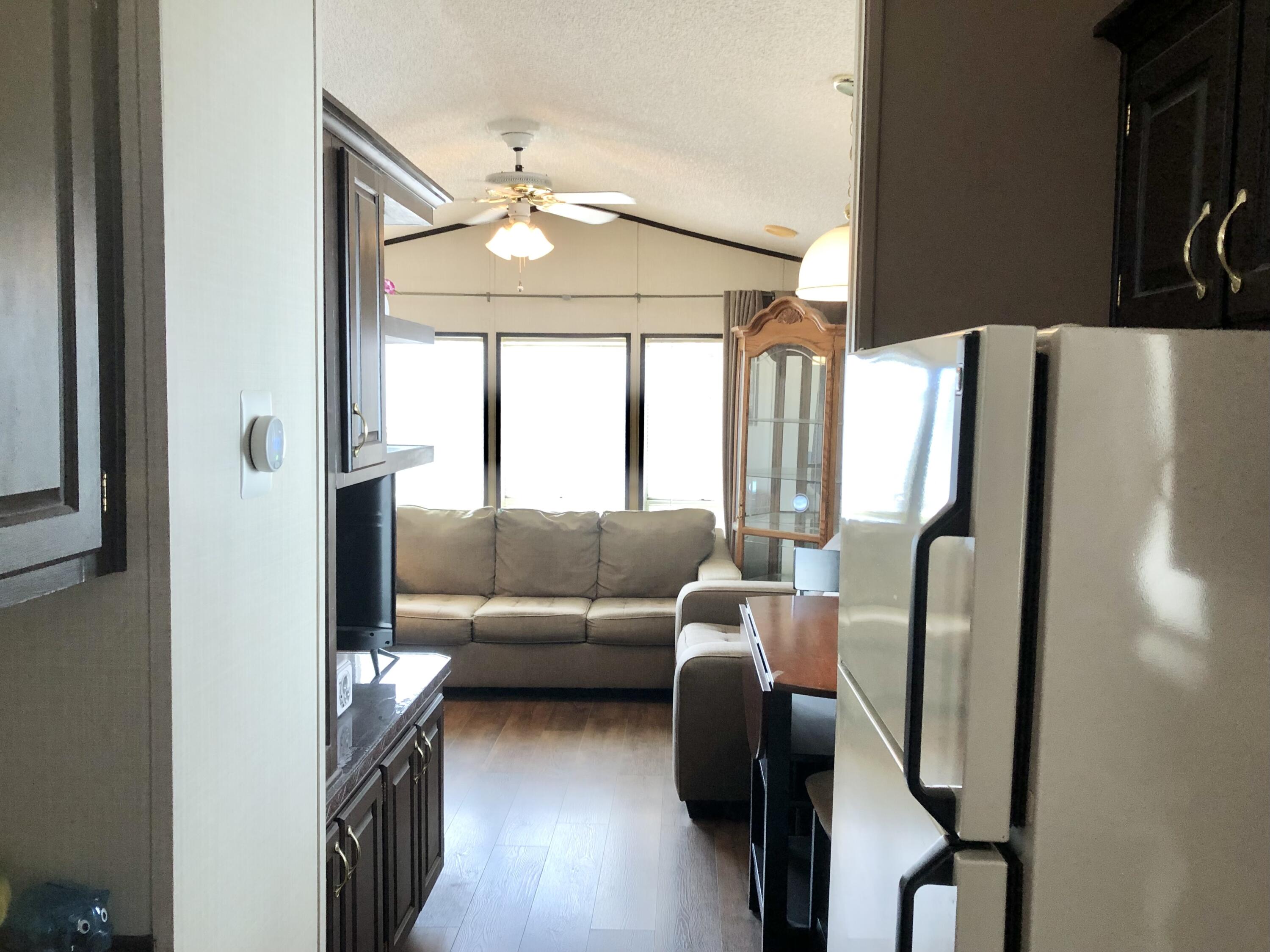 74711 Dillon Road Desert Hot Springs, CA 92241 - Photo 15 of 48 a living room with furniture and a large window