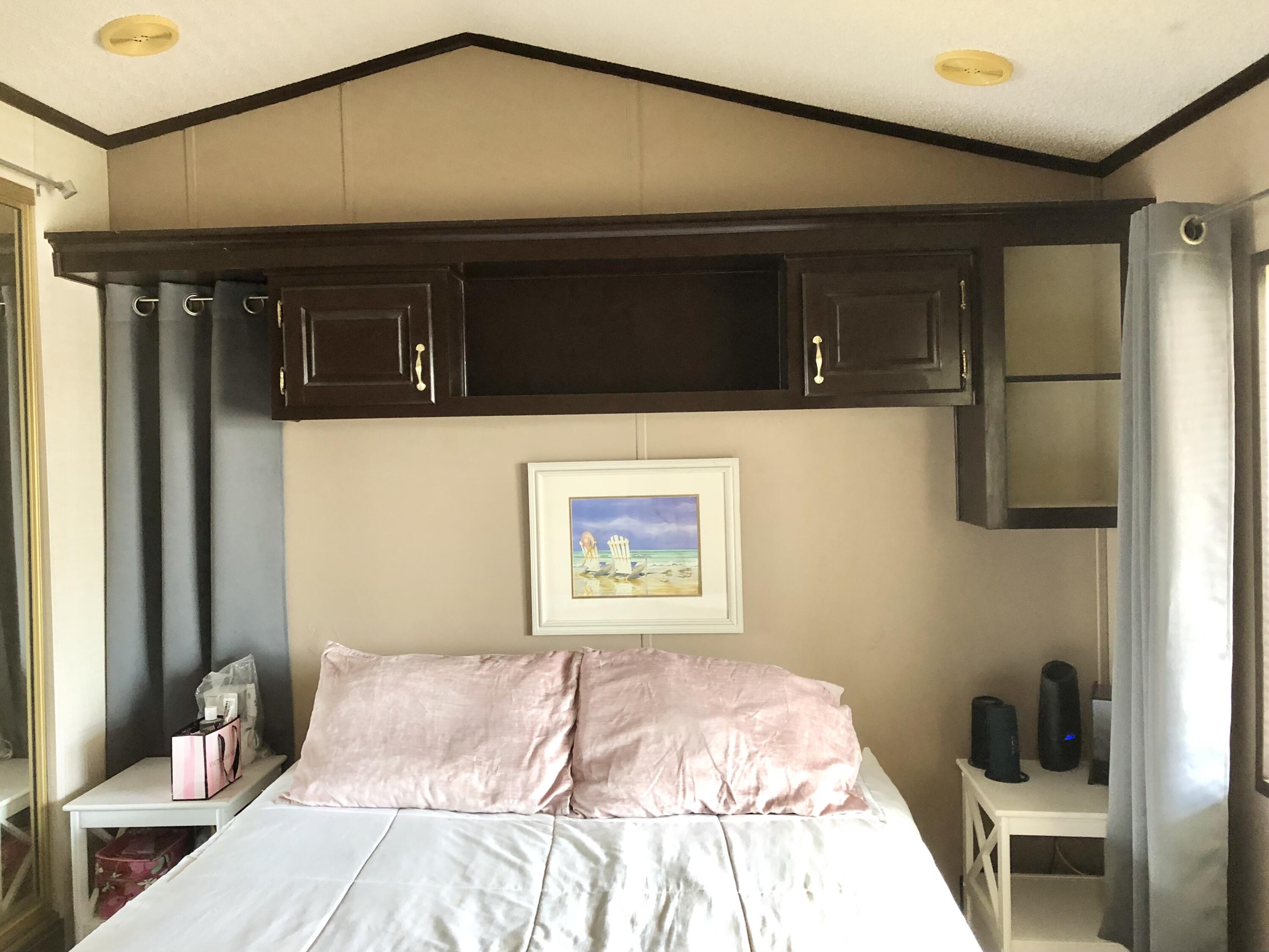 74711 Dillon Road Desert Hot Springs, CA 92241 - Photo 16 of 48 a bedroom with a bed and a mirror