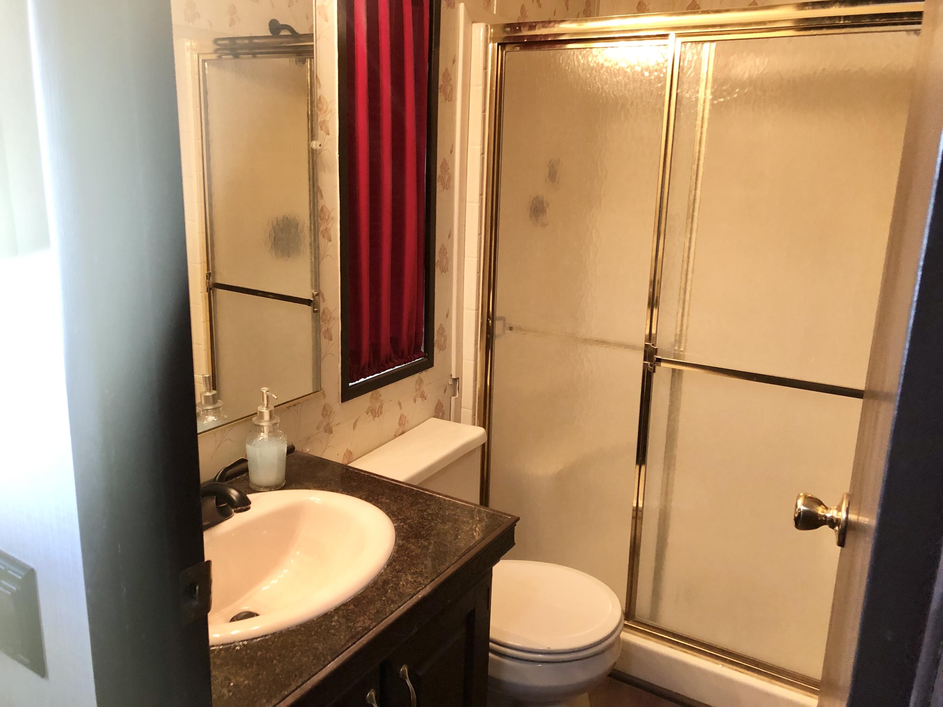 74711 Dillon Road Desert Hot Springs, CA 92241 - Photo 20 of 48 a bathroom with a granite countertop sink toilet and shower