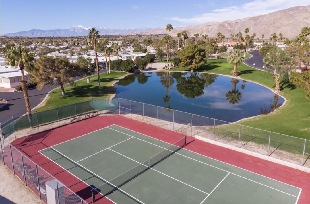 74711 Dillon Road Desert Hot Springs, CA 92241 - Photo 22 of 48 a view of a tennis ground and a cars park side of the road