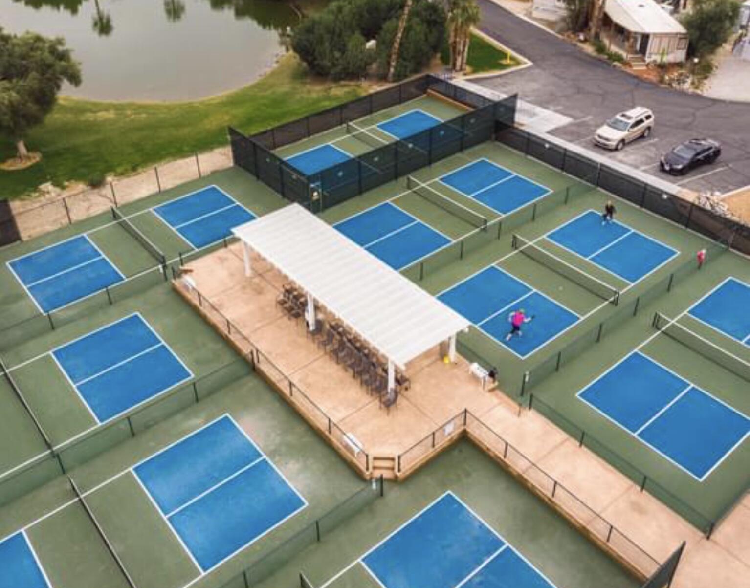 74711 Dillon Road Desert Hot Springs, CA 92241 - Photo 30 of 48 a view of a tennis ground with large windows