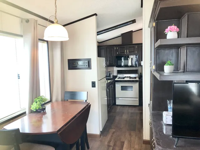 a view of a room with a window and wooden floor