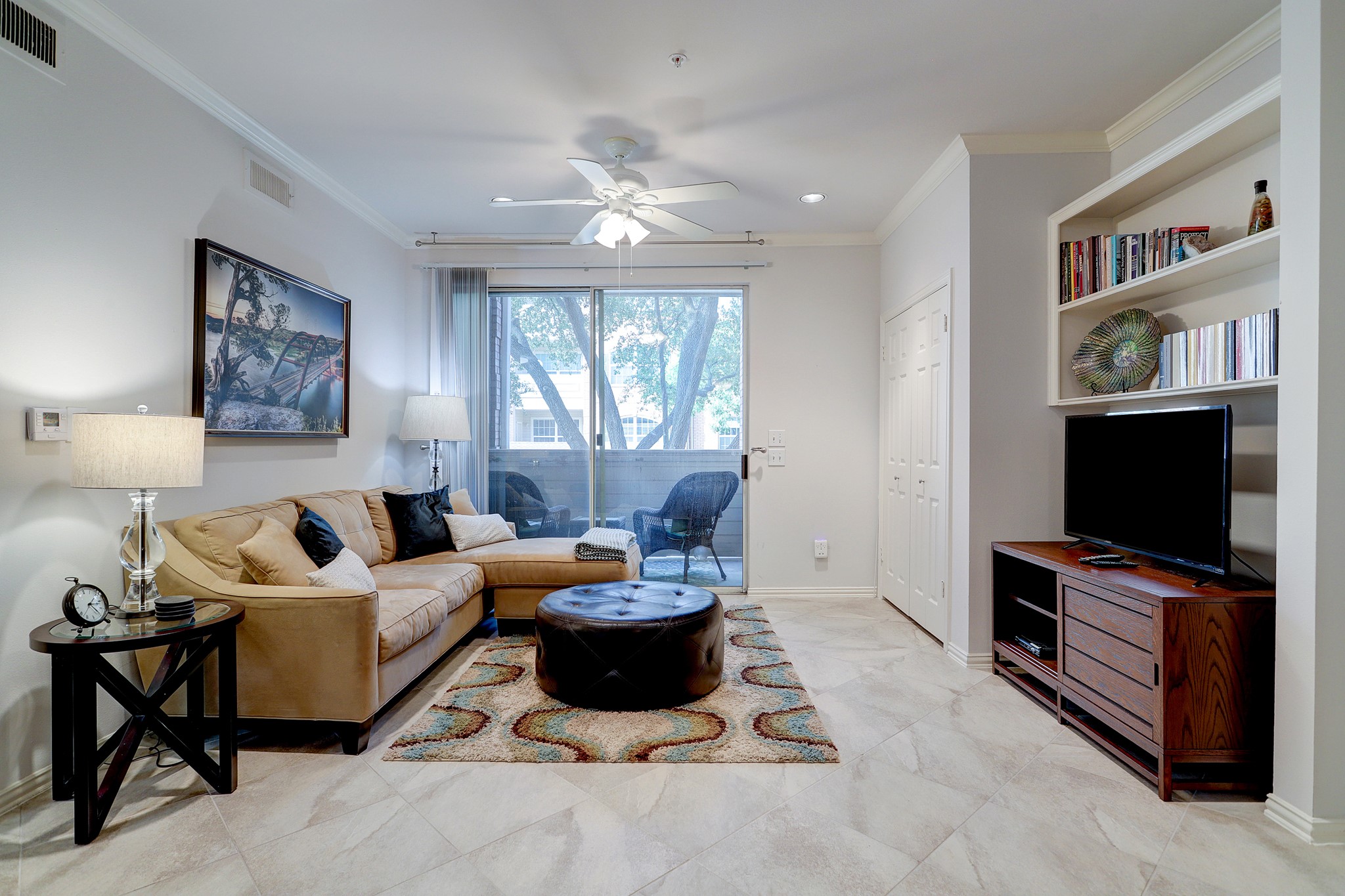 2111 Welch Street, Unit A129 Houston, TX 77019 - Photo 6 of 15 a living room with furniture and a flat screen tv