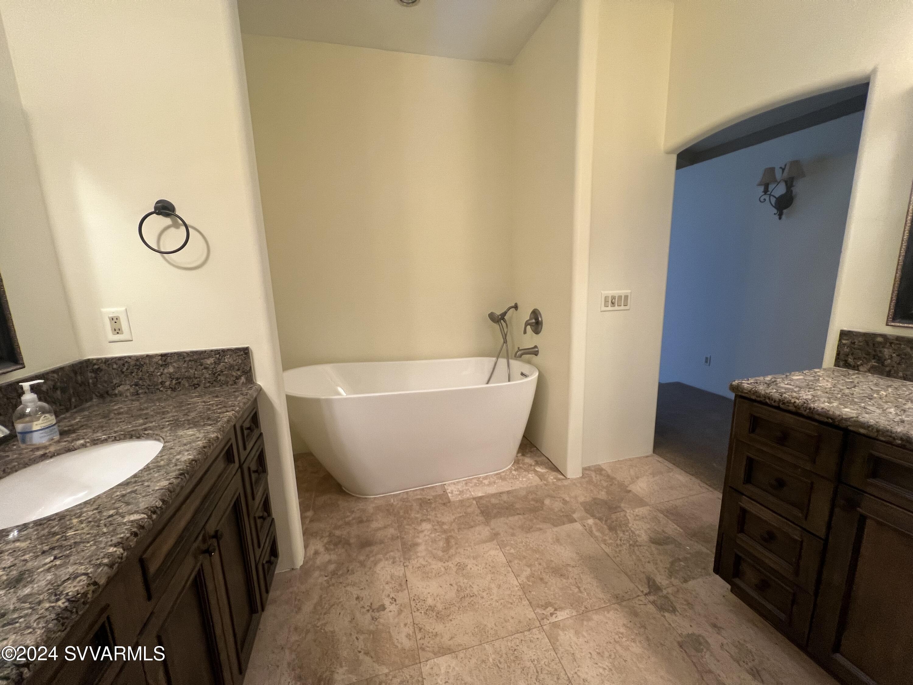 985 Rodeo Road Sedona, AZ 86336 - Photo 9 of 12 a bathroom with a granite countertop sink and a mirror