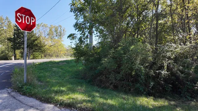 a view of sign board with a yard