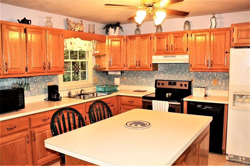 185 Davis Creek Road Murphy, NC 28906 - Photo 14 of 48 a kitchen with stainless steel appliances a stove a sink and a refrigerator