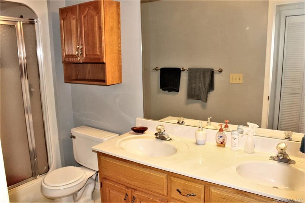 185 Davis Creek Road Murphy, NC 28906 - Photo 22 of 48 a bathroom with a sink a toilet and vanity