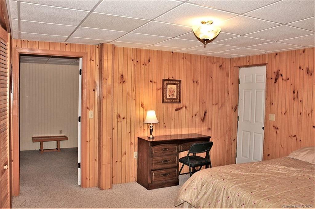 185 Davis Creek Road Murphy, NC 28906 - Photo 27 of 48 a bedroom with a bed and a chandelier