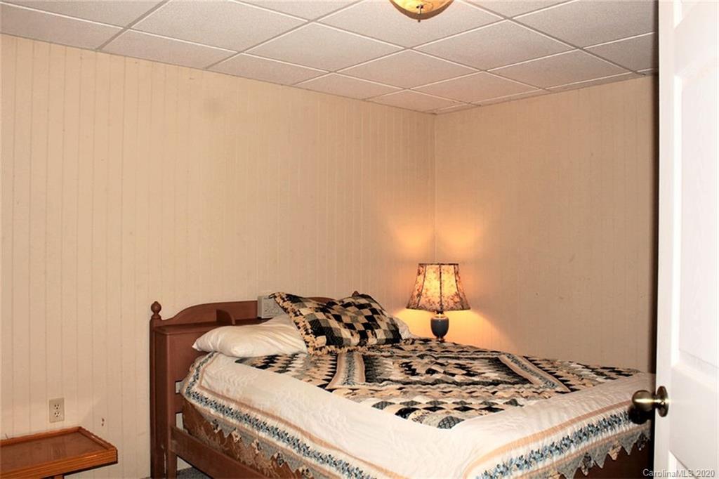 185 Davis Creek Road Murphy, NC 28906 - Photo 28 of 48 a bed sitting in a bedroom next to a window