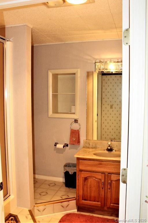 185 Davis Creek Road Murphy, NC 28906 - Photo 31 of 48 a bathroom with a sink and a mirror