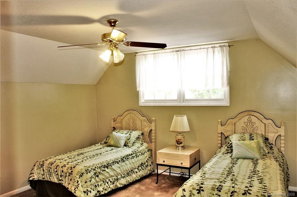 185 Davis Creek Road Murphy, NC 28906 - Photo 36 of 48 a bedroom with a bed and wooden floor