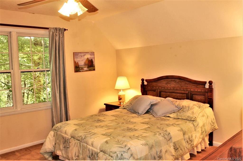 185 Davis Creek Road Murphy, NC 28906 - Photo 37 of 48 a large bed sitting in a bedroom next to a window