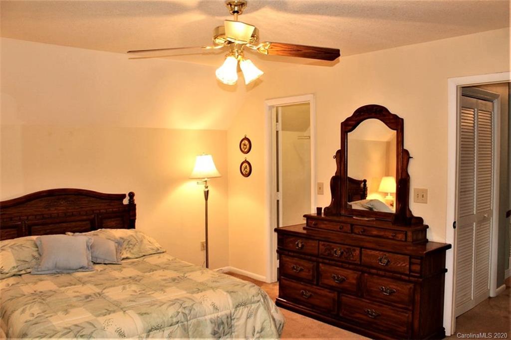 185 Davis Creek Road Murphy, NC 28906 - Photo 38 of 48 a bedroom with a bed and a chandelier