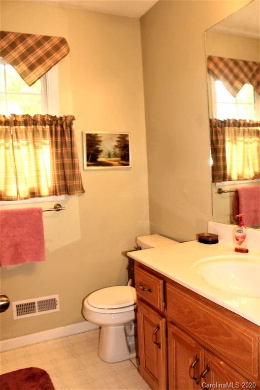 185 Davis Creek Road Murphy, NC 28906 - Photo 40 of 48 a bathroom with a sink a toilet and vanity