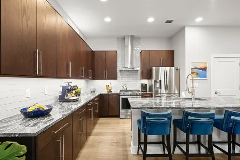 a kitchen with lots of counter top space appliances and cabinets