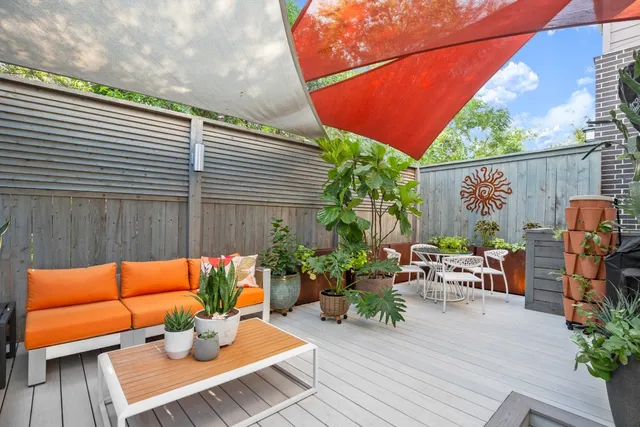 an outdoor sitting area with chairs and table
