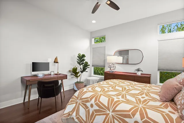 a bedroom with a bed a desk and chair