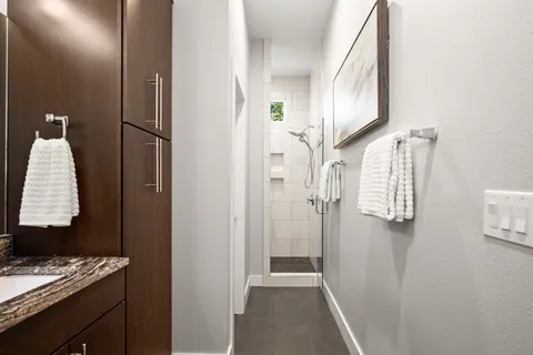 a view of hallway with mirror and window