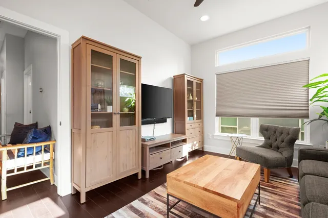 a living room with furniture a rug and a window