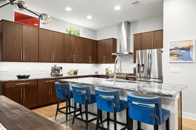 a kitchen with stainless steel appliances granite countertop a sink and cabinets