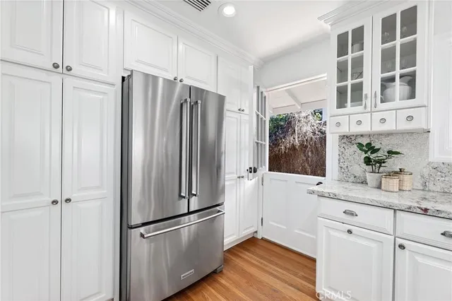 a kitchen with stainless steel appliances a refrigerator and cabinets