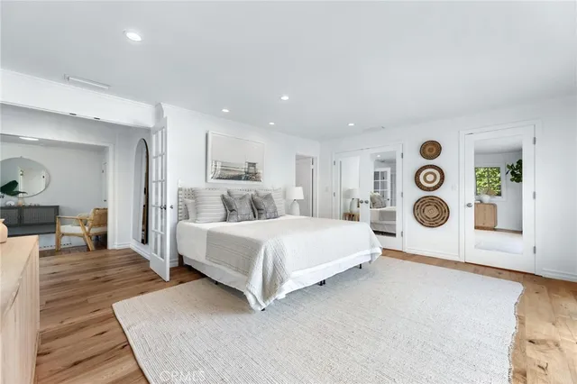 a spacious bedroom with a bed and lamp