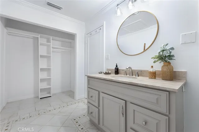 a bathroom with a granite countertop sink a mirror and vanity
