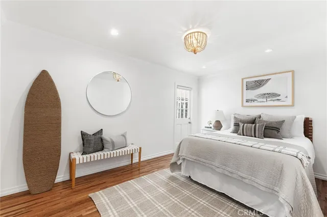 a bedroom with bed and a chandelier