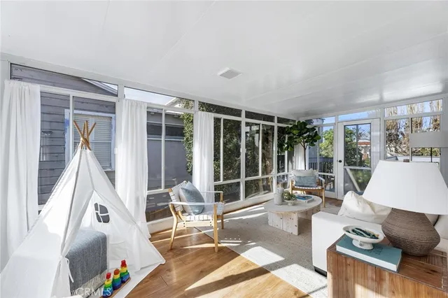 a living room with furniture and a floor to ceiling window