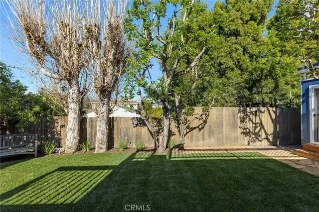 a view of backyard with swimming pool and green space