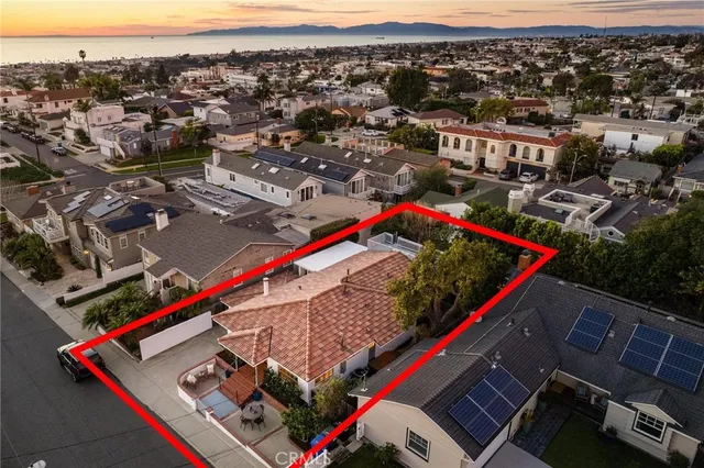a front view of house with yard and trees in the background