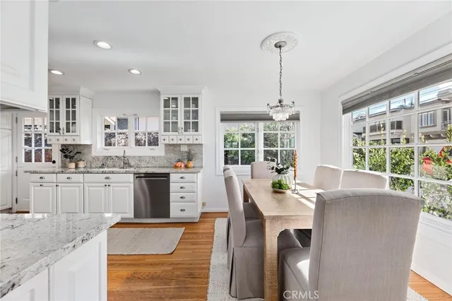 a dining room with stainless steel appliances kitchen island granite countertop a table and chairs in it