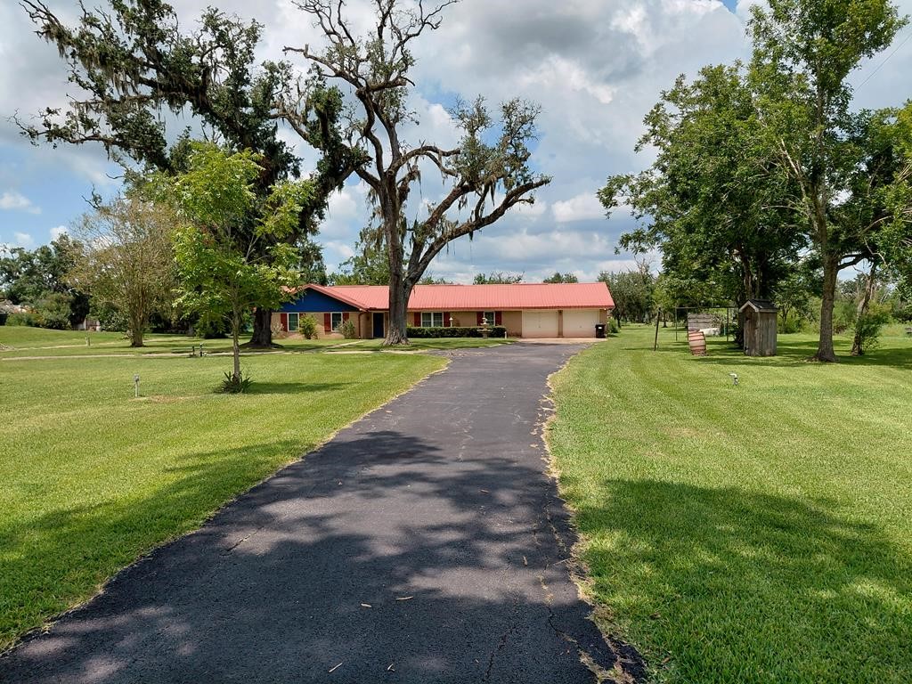 1231 County Road 201A Angleton, TX 77515 - Photo 2 of 26 a view of a park with large trees