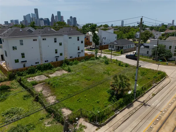 a view of a garden with a building in the background