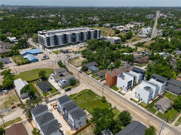 an aerial view of multiple houses with yard
