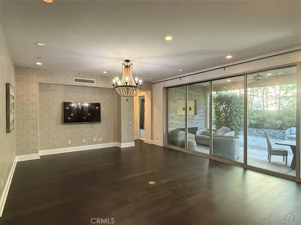 a view of a livingroom with furniture wooden floor and windows