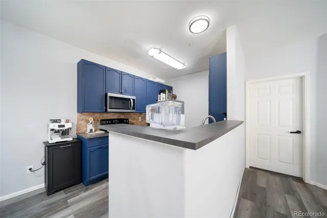 a kitchen with cabinets a sink and appliances